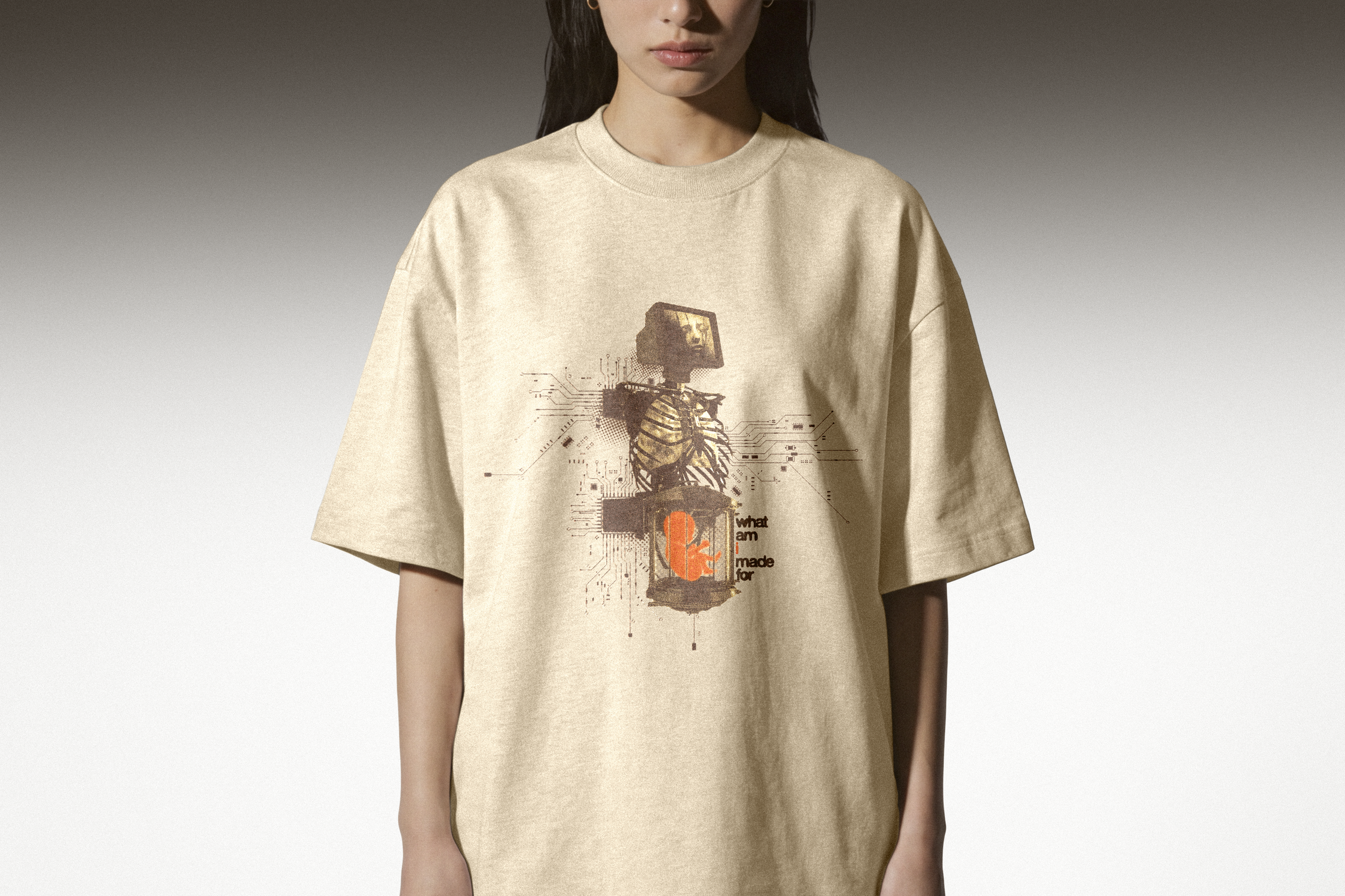 Person wearing a beige t-shirt with a graphic design on a plain background